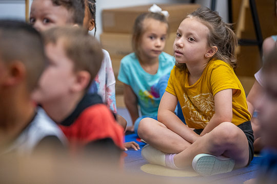 Young students attentively listening in class.