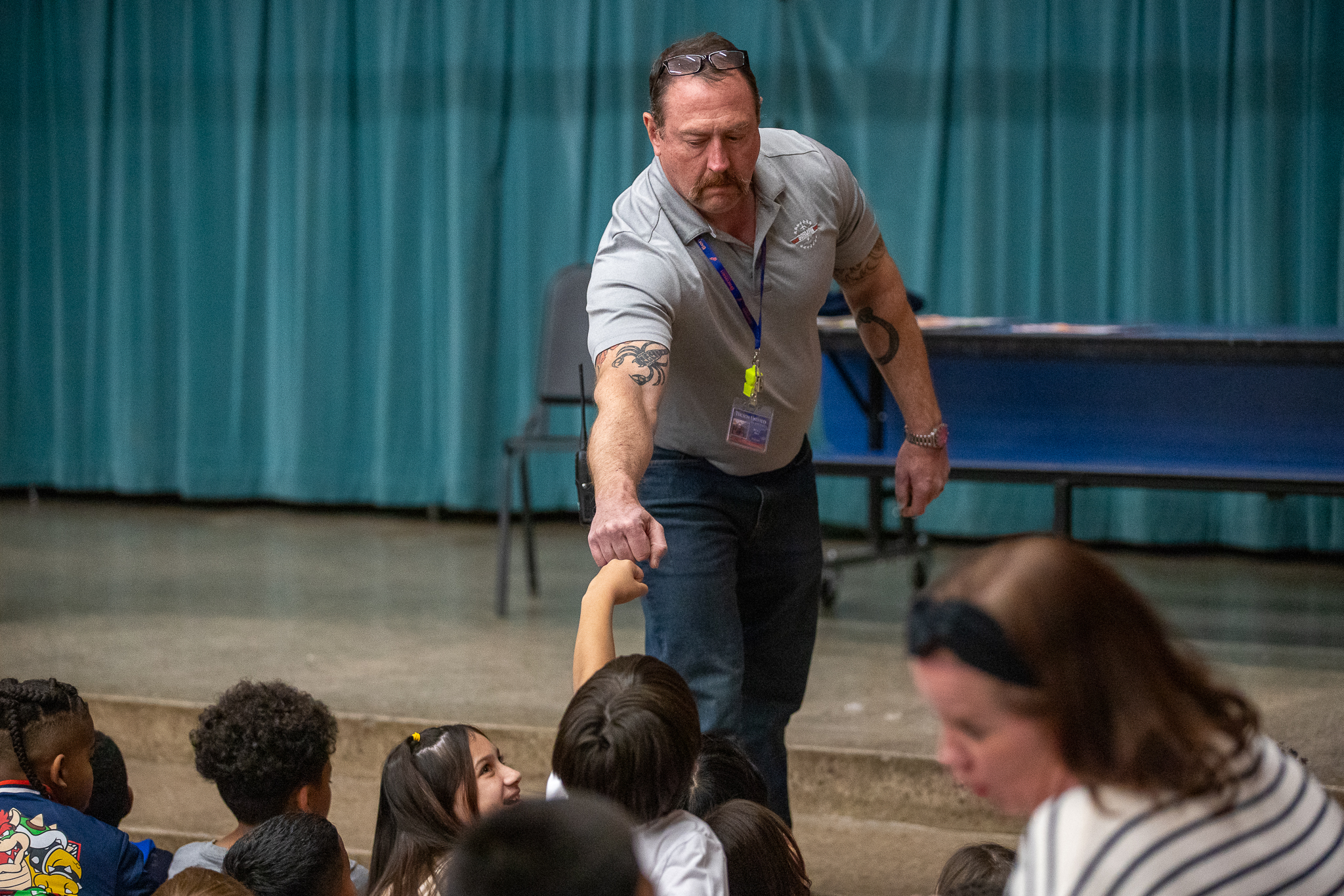 Borman's principal fist bumps a student