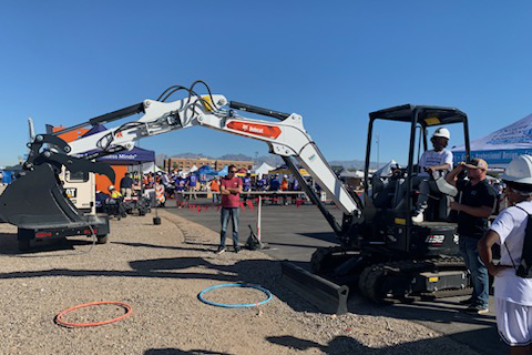 Construction workers demonstrate their equipment