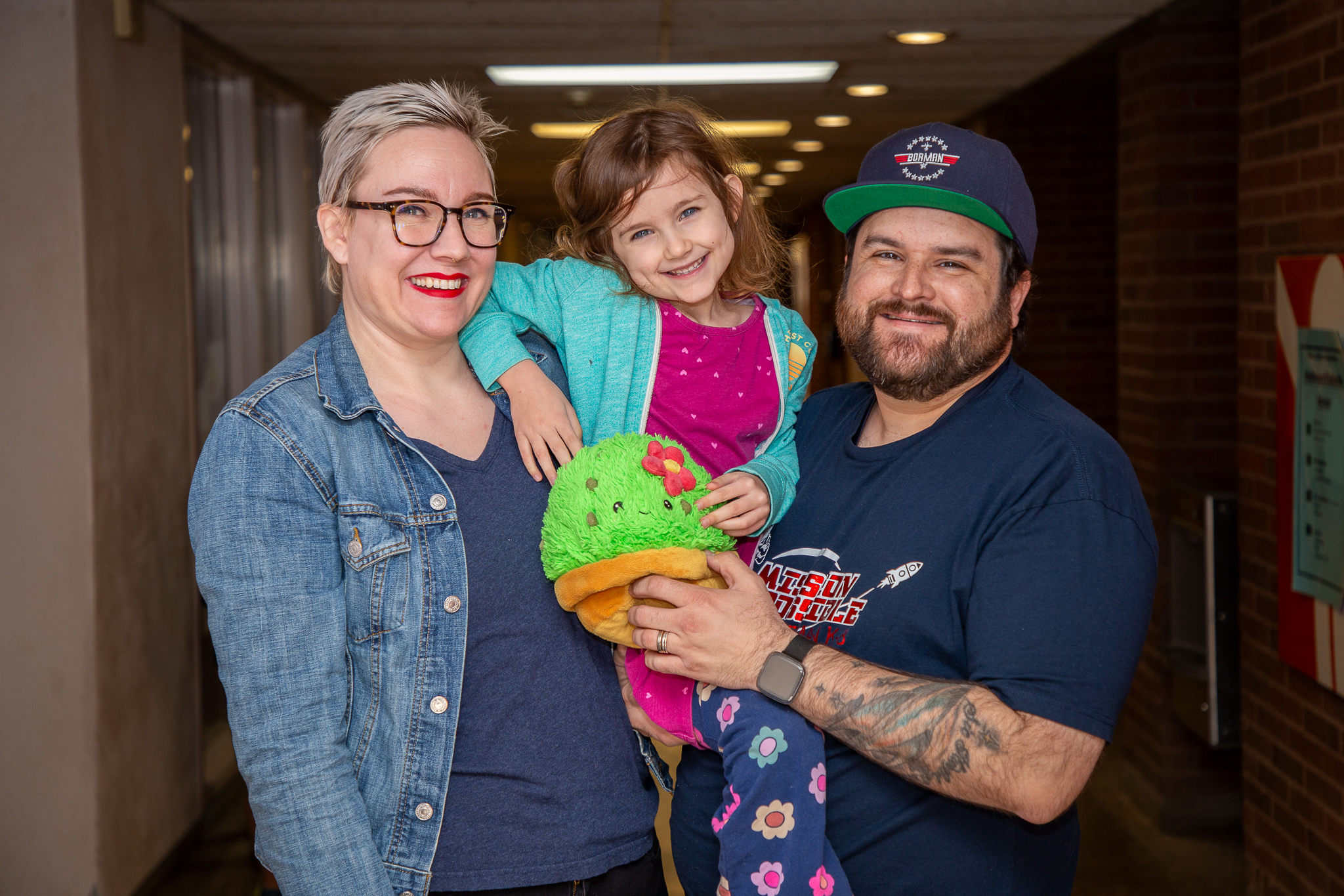 Alyssa, Luna and Nick LaRue smile in the hallway