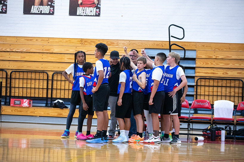 The Borman boys basketball team goes into a huddle