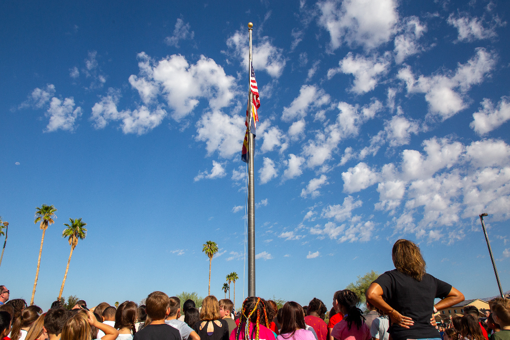 Students look up at the American flag